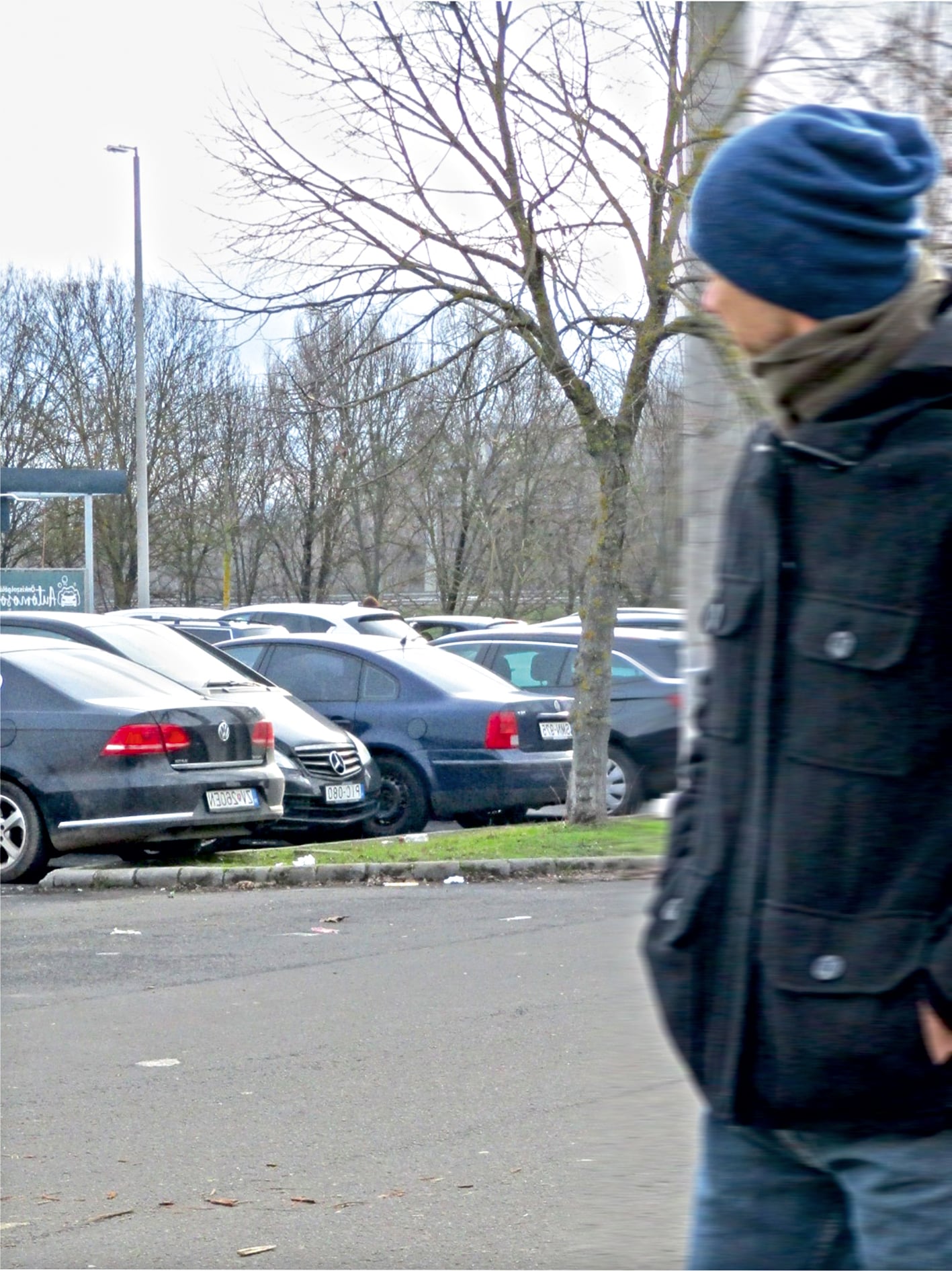 Person walking near parked cars